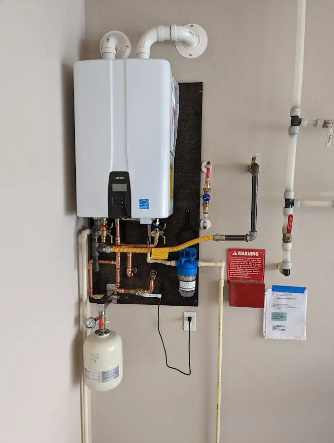 Professional plumber installing copper piping in a Berea home